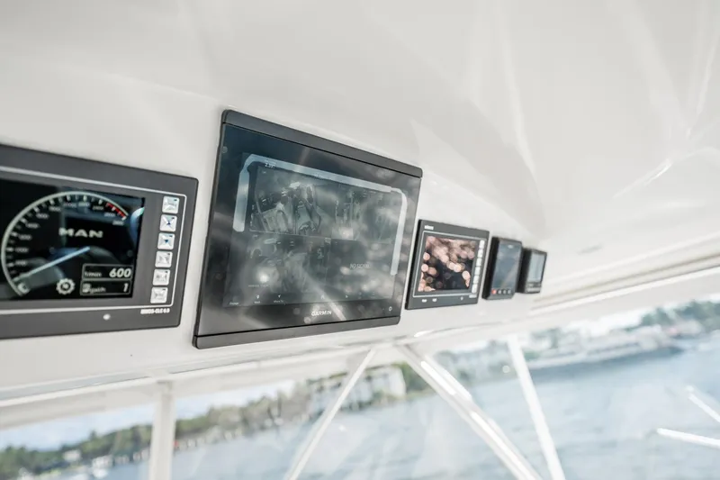 Slide: The Image of 2021 Viking 54 Convertible yacht dashboard with advanced navigation displays. - 68