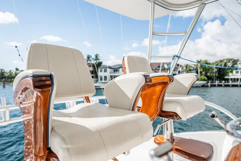 Slide: The Image of Luxury seating on 2021 Viking 54 Convertible yacht, with waterfront view. - 70