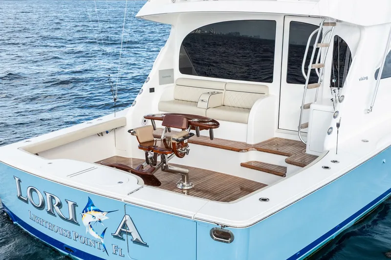 Slide: The Image of 2021 Viking 54 Convertible yacht with elegant deck and fishing chair on open water. - 74