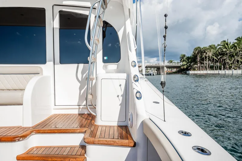 Slide: The Image of 2021 Viking 54 Convertible yacht deck with wooden steps and ocean view. - 78