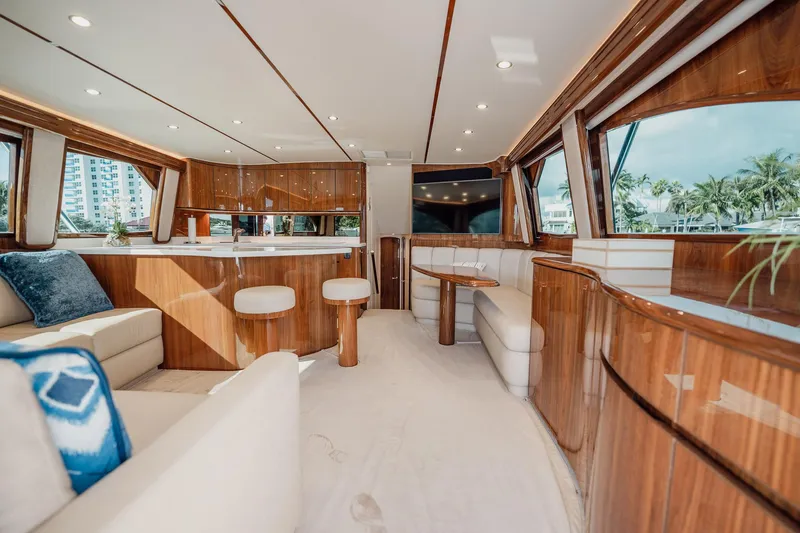 Slide: The Image of Luxurious interior of 2021 Viking 54 Convertible yacht with elegant wood finishes and plush seating. - 8