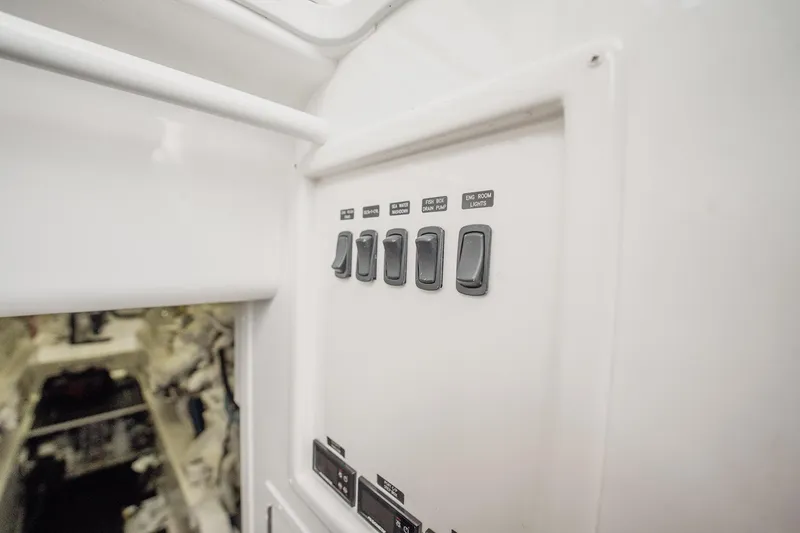 Slide: The Image of Control panel inside 2021 Viking 54 Convertible yacht, featuring labeled switches. - 86