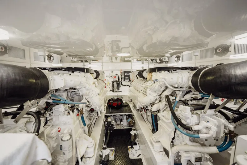 Slide: The Image of Engine room of 2021 Viking 54 Convertible yacht, showcasing powerful machinery and clean design. - 88