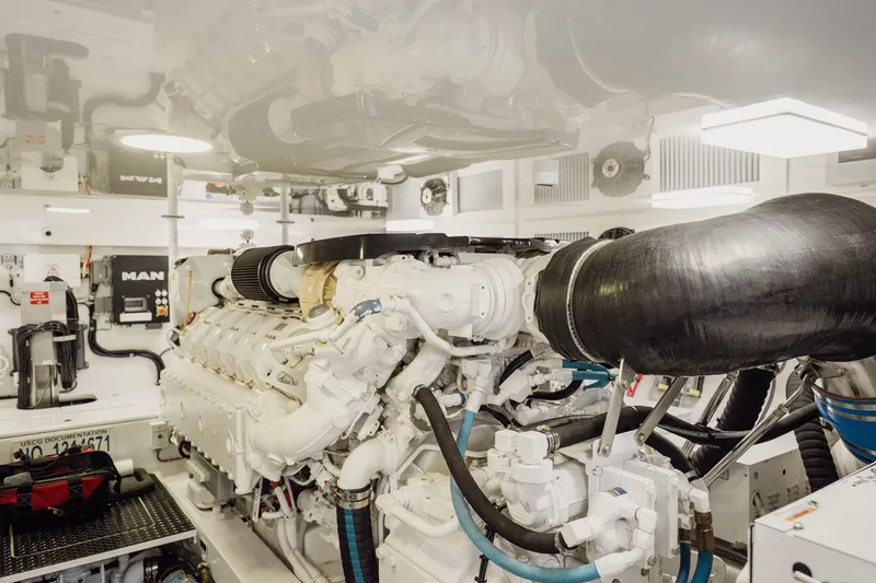 Slide: The Image of Engine room of 2021 Viking 54 Convertible yacht, featuring advanced machinery and components. - 89