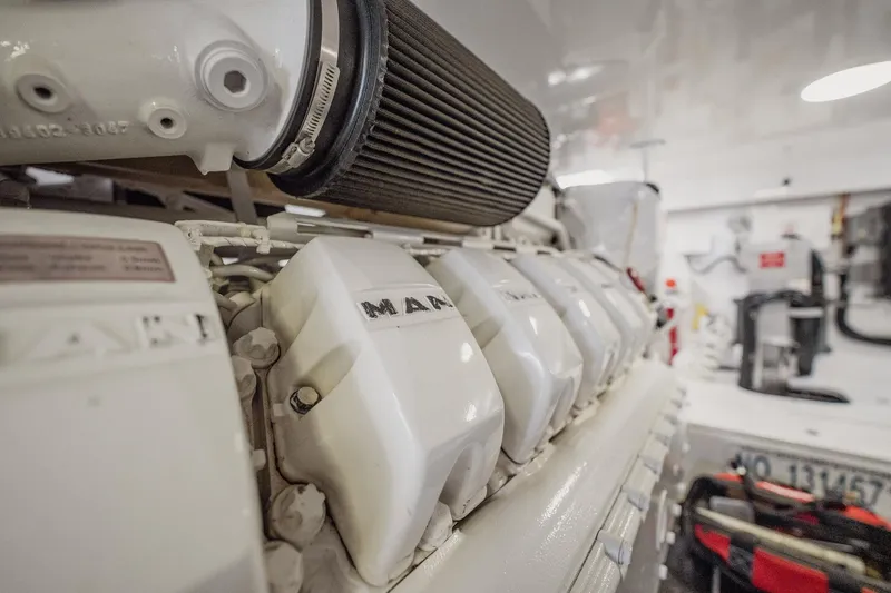 Slide: The Image of Engine room of 2021 Viking 54 Convertible yacht, featuring MAN engine components. - 90