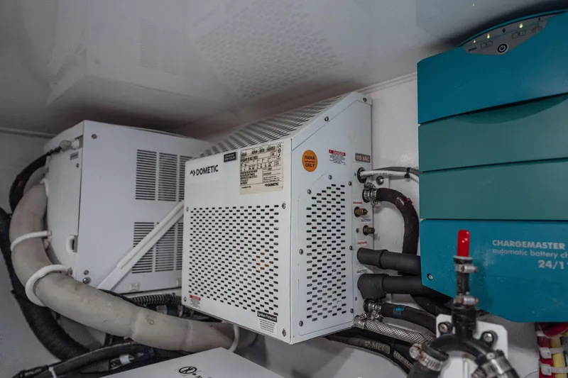 Slide: The Image of Engine room of 2021 Viking 54 Convertible with Dometic and battery charger systems. - 95