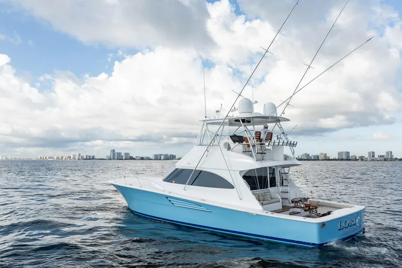 Slide: The Image of 2021 Viking 54 Convertible yacht on open water under a cloudy sky. - 97