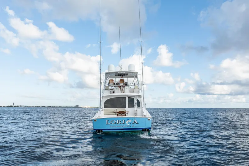 Slide: The Image of 2021 Viking 54 Convertible yacht on open sea under blue sky. - 98