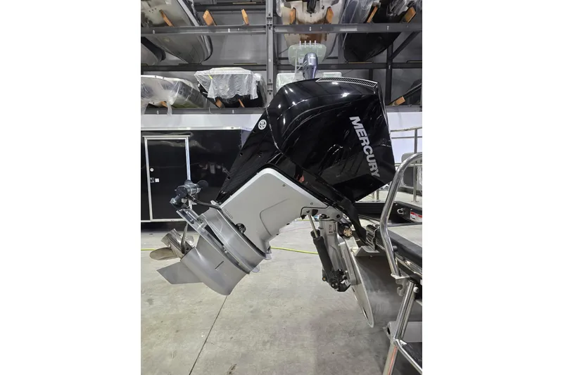 Slide: The Image of 2023 Bennington QX 25 QXSBWA with Mercury outboard motor in storage facility. - 10