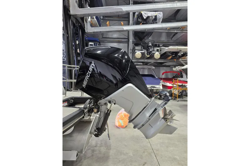 Slide: The Image of 2023 Bennington QX 25 QXSBWA with Mercury outboard motor in storage facility. - 11
