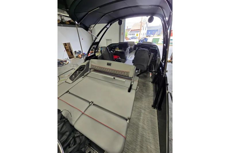 Slide: The Image of 2023 Bennington QX 25 QXSBWA pontoon boat interior with sleek seating and modern design. - 7