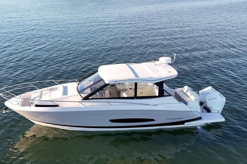 Slide: The Image of 2026 Regal 36 XO luxury boat cruising on calm waters. - 10