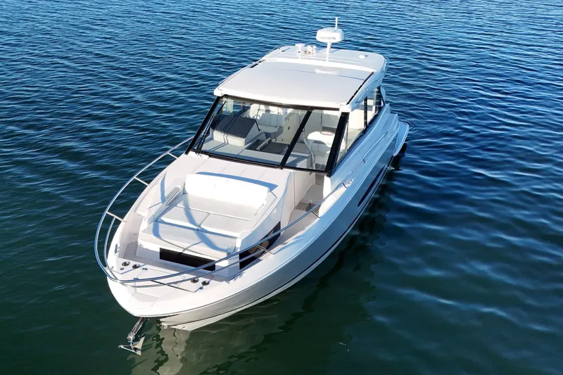 Slide: The Image of 2026 Regal 36 XO boat on calm blue water, showcasing sleek design and modern features. - 12