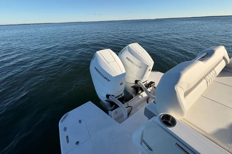 Slide: The Image of 2026 Regal 36 XO boat with dual Mercury outboard engines on open water. - 15