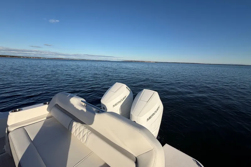 Slide: The Image of 2026 Regal 36 XO boat with Mercury engines on calm water. - 16