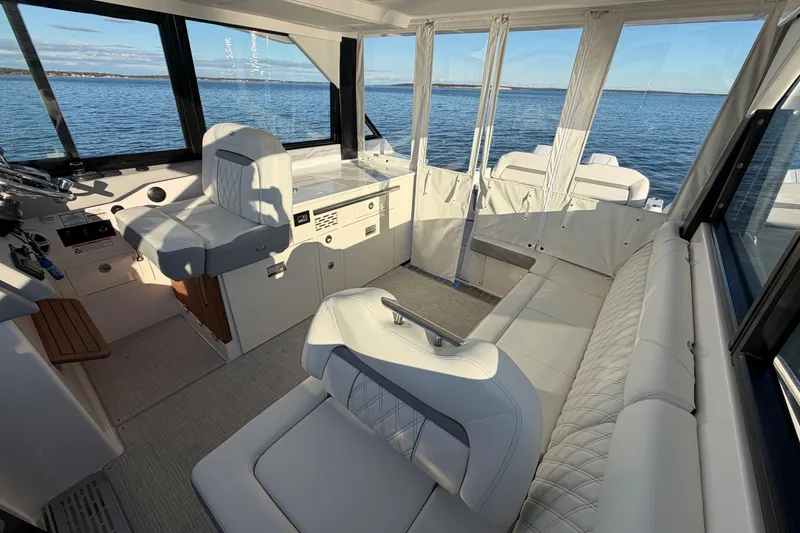 Slide: The Image of Interior of 2026 Regal 36 XO yacht with luxurious seating and ocean view. - 20
