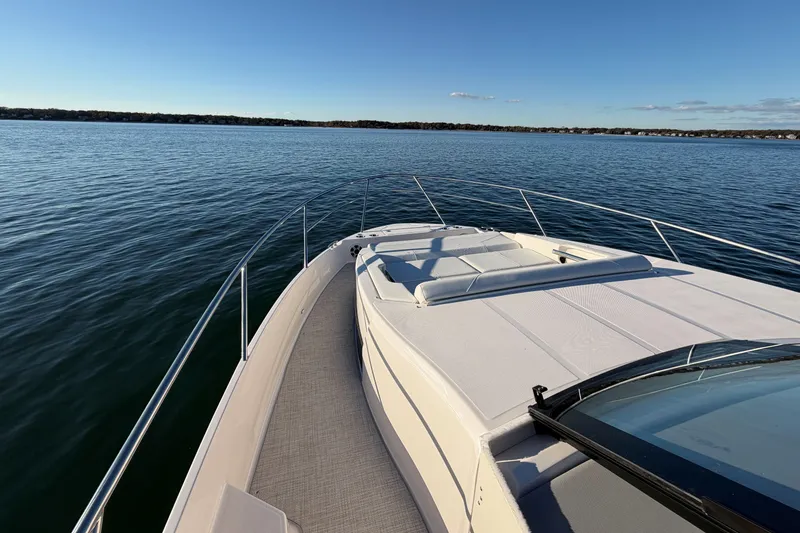 Slide: The Image of 2026 Regal 36 XO yacht cruising on serene waters under clear blue skies. - 26