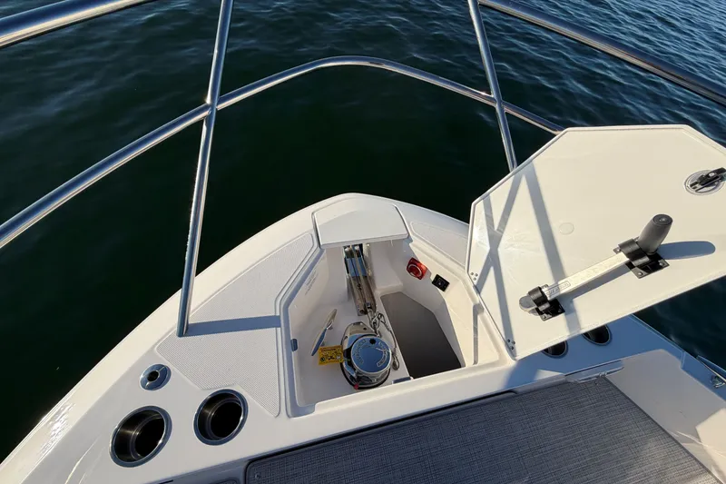 Slide: The Image of 2026 Regal 36 XO boat bow with open anchor locker, stainless steel railings. - 28