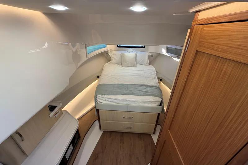 Slide: The Image of Luxurious cabin interior of 2026 Regal 36 XO yacht with cozy bed and wooden accents. - 30