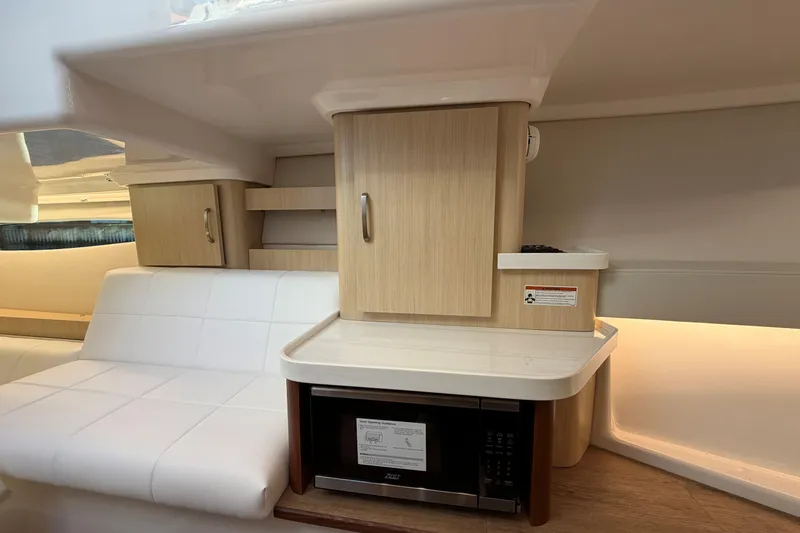 Slide: The Image of Interior of 2026 Regal 36 XO yacht with white seating and wooden cabinetry. - 33