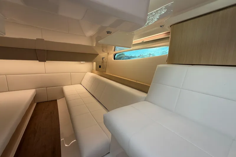 Slide: The Image of Luxurious interior of 2026 Regal 36 XO yacht with white seating and wood accents. - 34