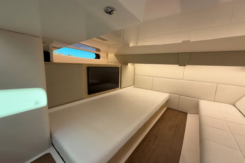 Slide: The Image of Interior of 2026 Regal 36 XO yacht, featuring modern seating and a sleek design. - 36
