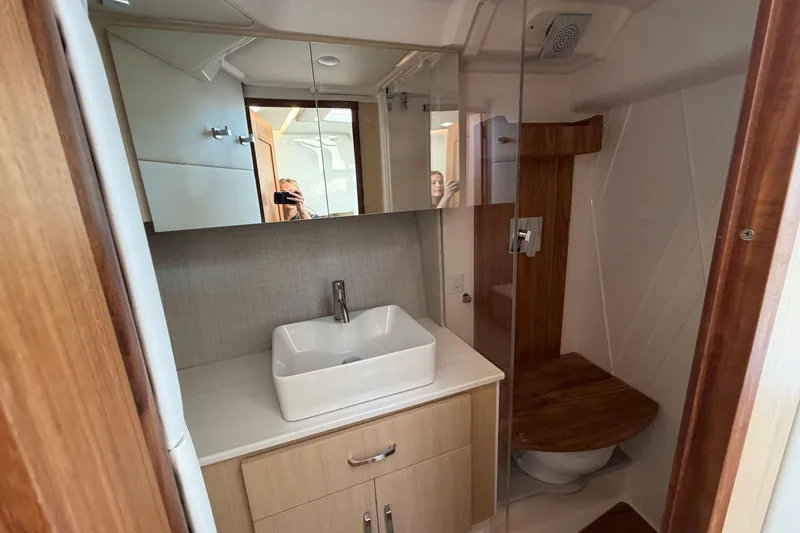 Slide: The Image of Modern bathroom in 2026 Regal 36 XO yacht with sleek sink and wooden accents. - 38