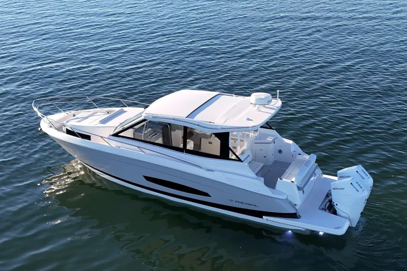 Slide: The Image of 2026 Regal 36 XO luxury boat cruising on calm waters. - 7