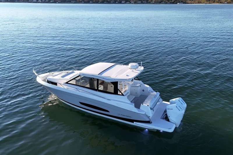 Slide: The Image of 2026 Regal 36 XO boat on calm water, showcasing sleek design and twin outboard engines. - 9