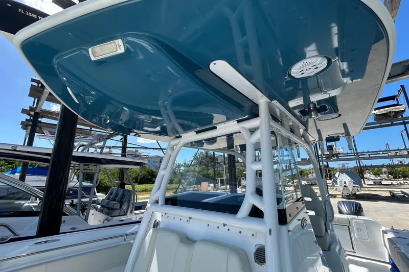 Slide: The Image of 2022 Cape Horn 36 boat with blue T-top and white frame in a marina setting. - 19