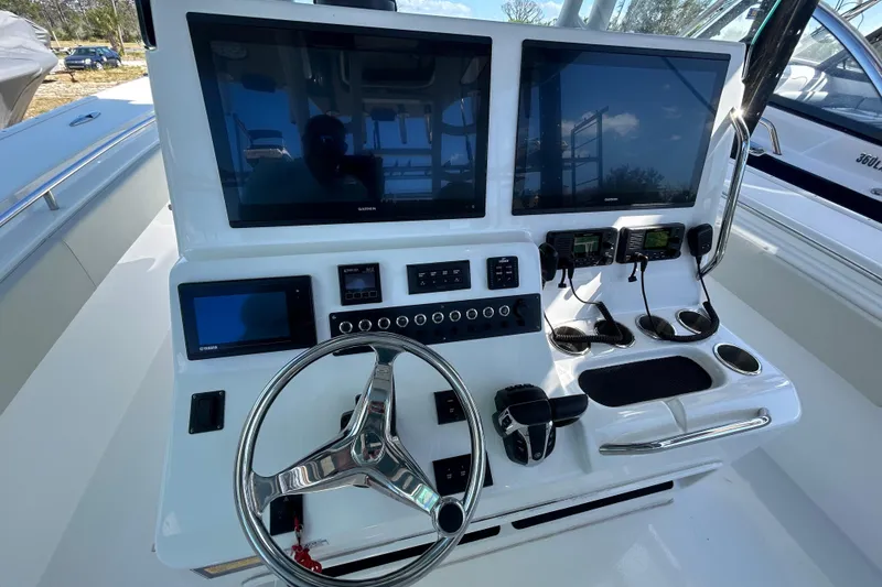 Slide: The Image of 2022 Cape Horn 36 boat dashboard with dual Garmin displays and steering wheel. - 20