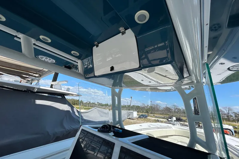 Slide: The Image of Interior view of a 2022 Cape Horn 36 boat, showcasing the helm and overhead compartments. - 26