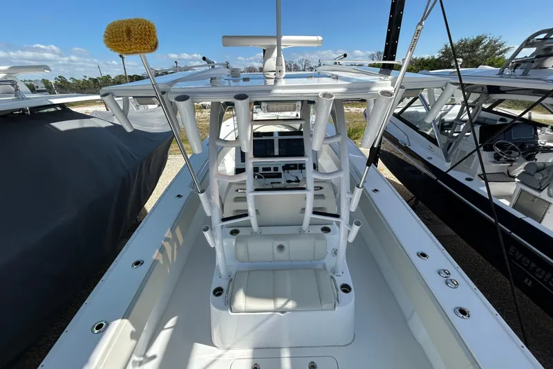 Slide: The Image of 2022 Cape Horn 36 boat interior with helm station and seating, docked outdoors. - 43