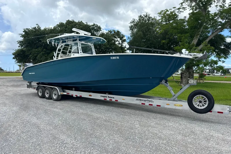The Image of 2022 Cape Horn 36 boat on trailer, parked outdoors under cloudy sky. - 1