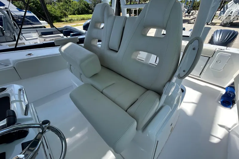 Slide: The Image of 2022 Cape Horn 36 boat interior with plush white seating and steering wheel. - 24