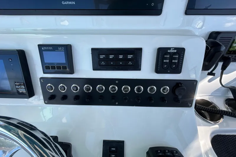 Slide: The Image of Control panel of a 2022 Cape Horn 36 boat with various switches and displays. - 28