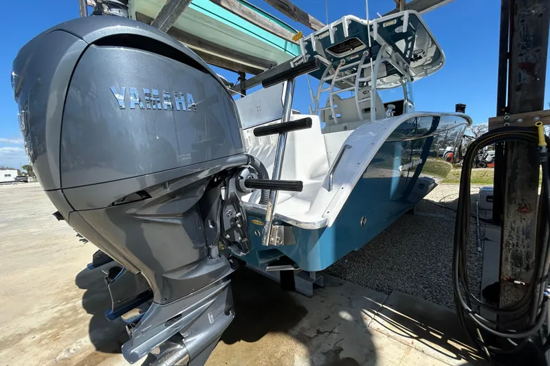 Slide: The Image of 2022 Cape Horn 36 boat with Yamaha outboard motor, docked under clear blue sky. - 48