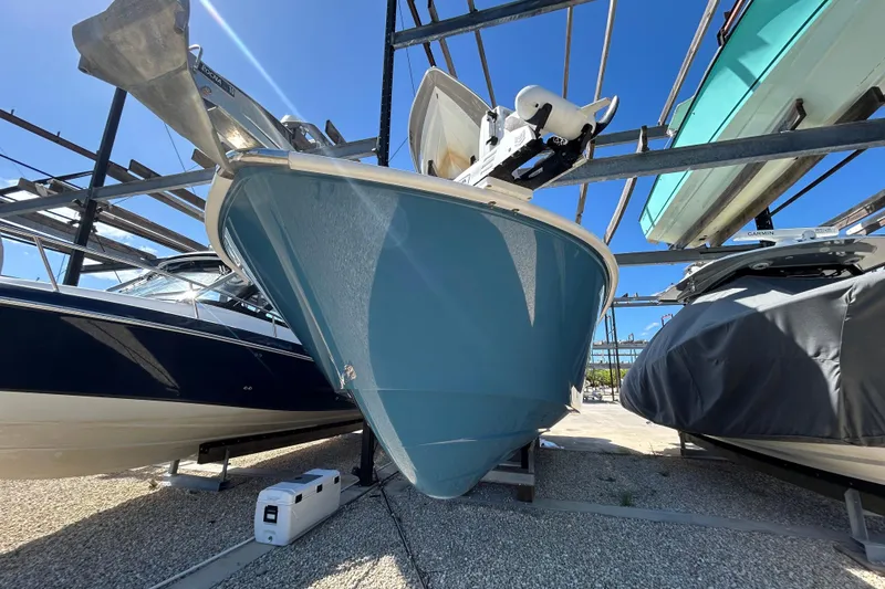 Slide: The Image of 2022 Cape Horn 36 boat in storage, blue hull, sunny day, surrounded by other boats. - 50