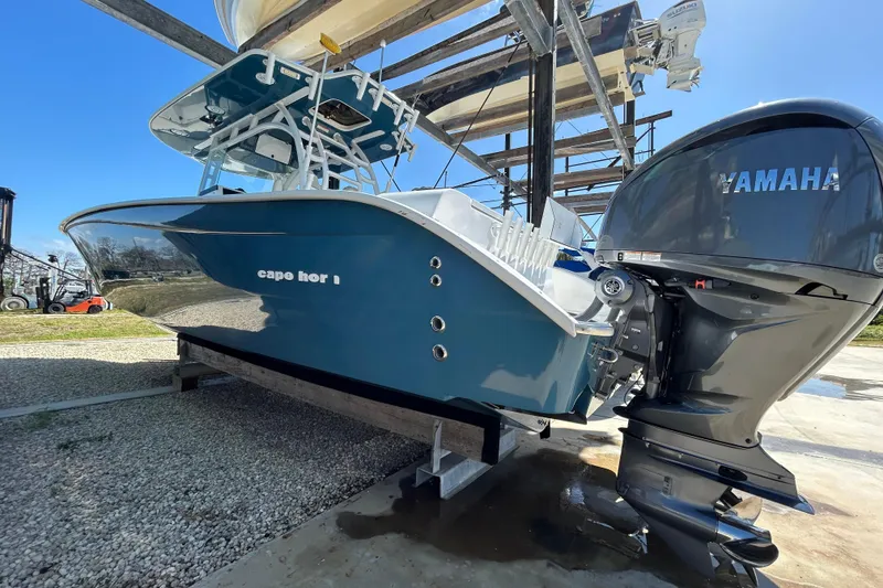 Slide: The Image of 2022 Cape Horn 36 boat with Yamaha engine, displayed on a stand outdoors. - 53