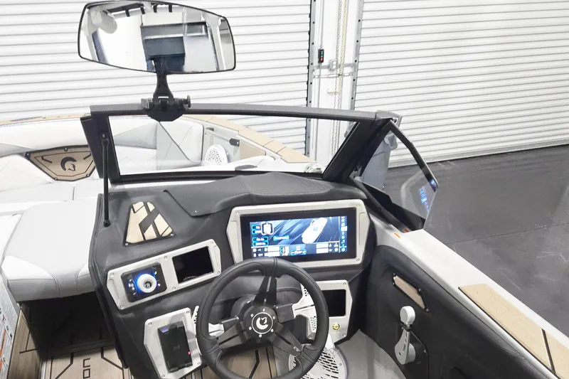 Slide: The Image of 2026 Centurion Nv243 boat dashboard with touchscreen display and steering wheel. - 10