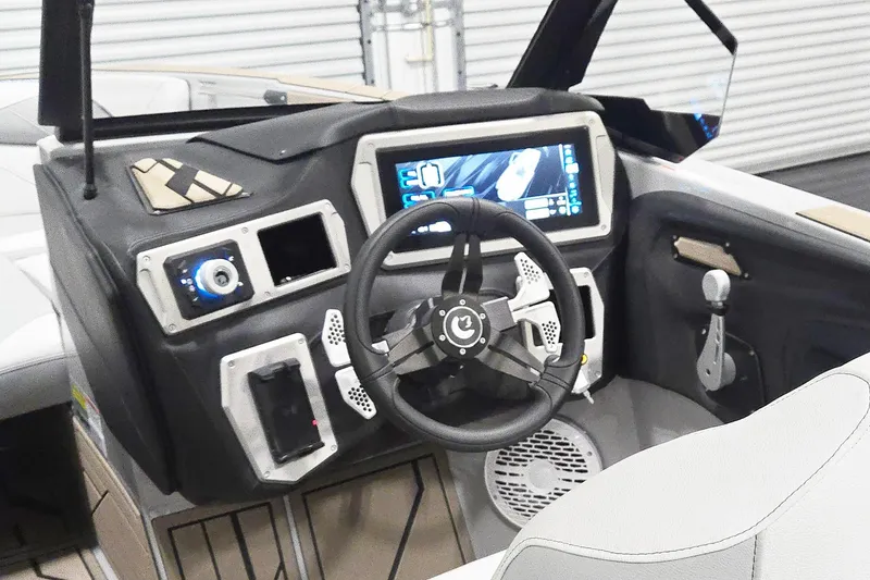 Slide: The Image of Interior of a 2026 Centurion Nv243 boat featuring a modern dashboard and steering wheel. - 11