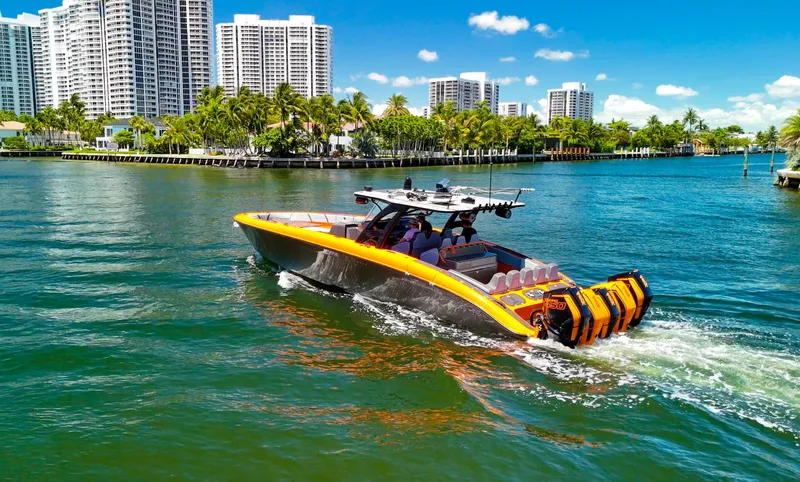 Slide: The Image of 2022 Midnight Express 43 Open boat cruising in a scenic waterfront cityscape. - 10