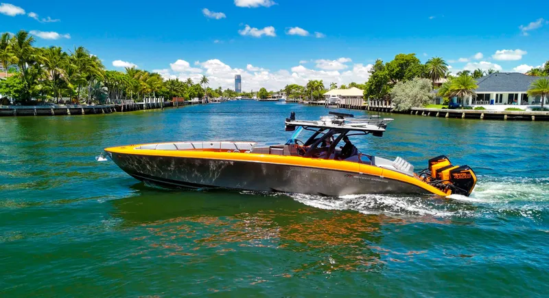 Slide: The Image of 2022 Midnight Express 43 Open boat cruising on a sunny, tropical waterway. - 11