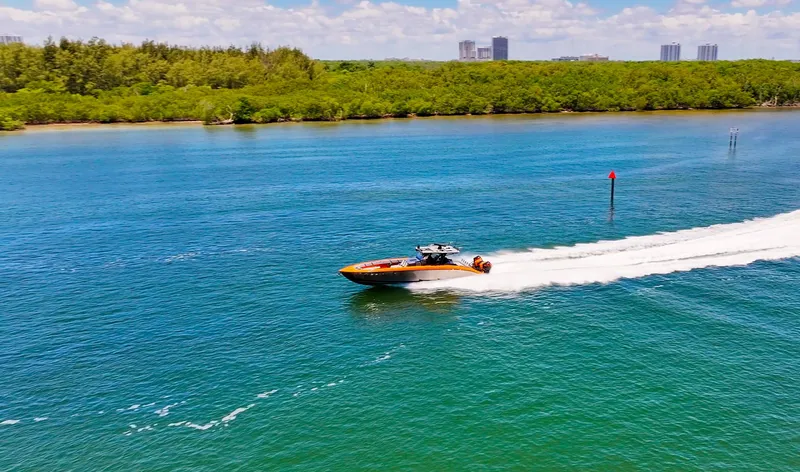 Slide: The Image of 2022 Midnight Express 43 Open speedboat cruising on a scenic waterway. - 16