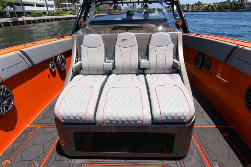 Slide: The Image of 2022 Midnight Express 43 Open boat interior with stylish seating and vibrant orange accents. - 19