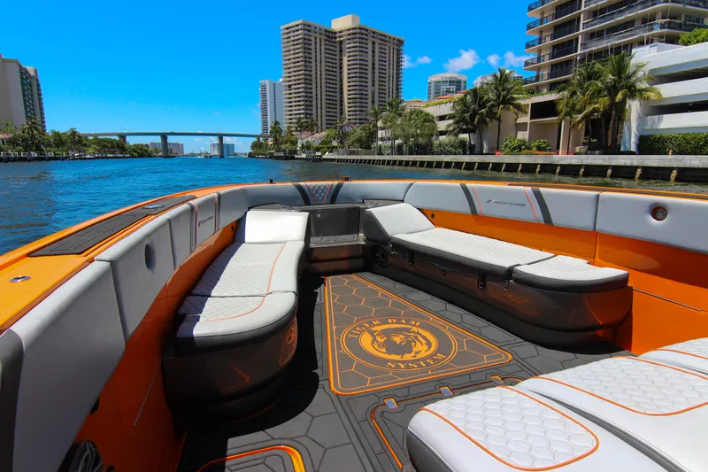 Slide: The Image of 2022 Midnight Express 43 Open boat interior with luxurious seating, cruising on a sunny waterway. - 21