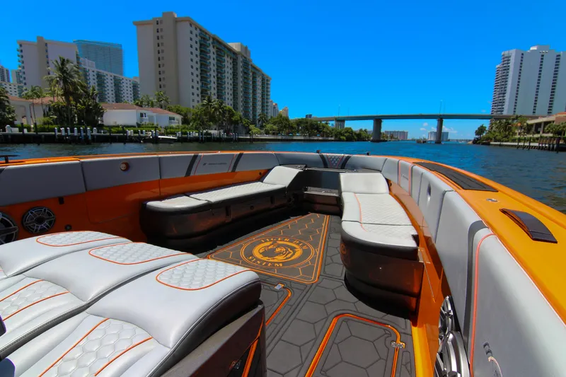 Slide: The Image of 2022 Midnight Express 43 Open boat interior with luxurious seating and vibrant orange accents. - 22