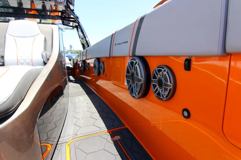 Slide: The Image of 2022 Midnight Express 43 Open boat interior with orange accents and modern speakers. - 23