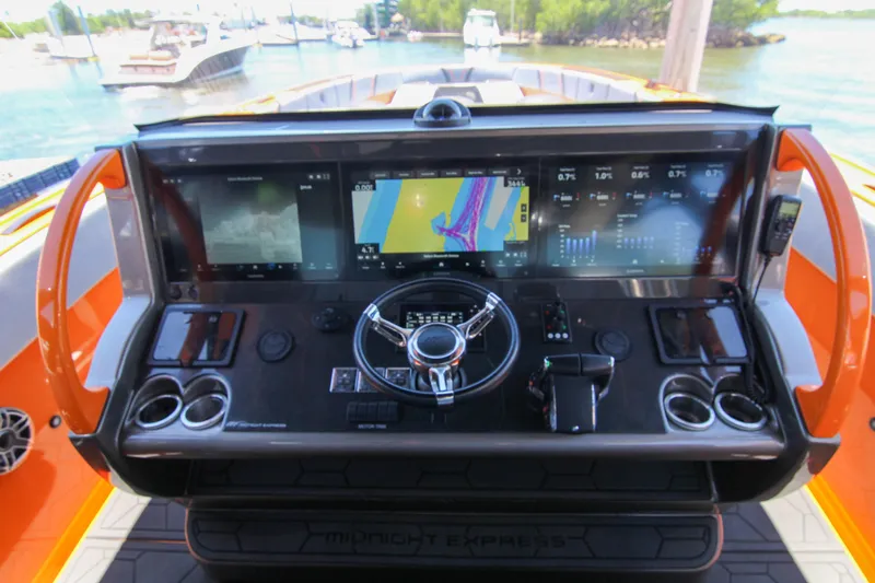 Slide: The Image of Cockpit of 2022 Midnight Express 43 Open boat with advanced navigation system. - 25