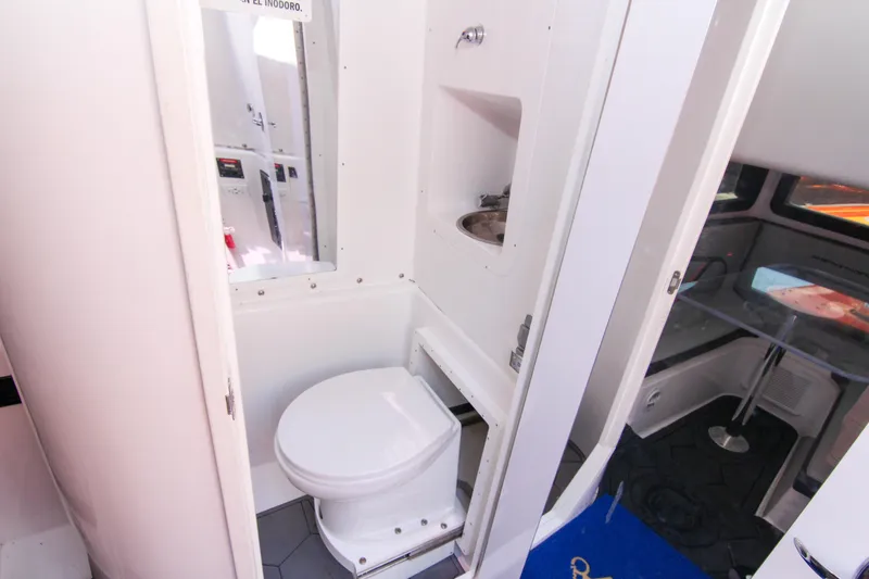 Slide: The Image of 2022 Midnight Express 43 Open boat bathroom interior with toilet and sink. - 28